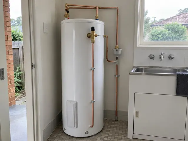 Indoor hot water tank beside a sink in a laundry or utility room in Ryde